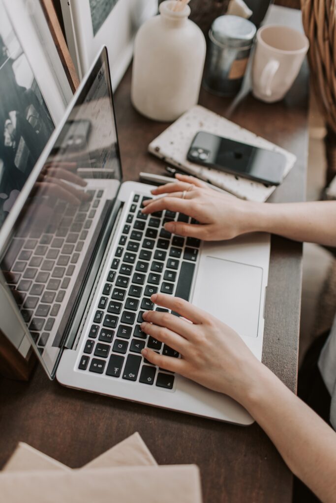 A woman working at a laptop, embodying innovative marketing approaches in action.